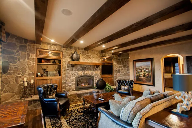 Tuscan Villa custom home — Living Room Stone Fireplace Feature Wall