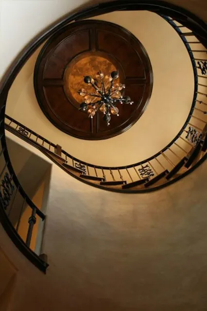 Tuscan Villa custom home — Spiral Staircase Chandelier Undershot