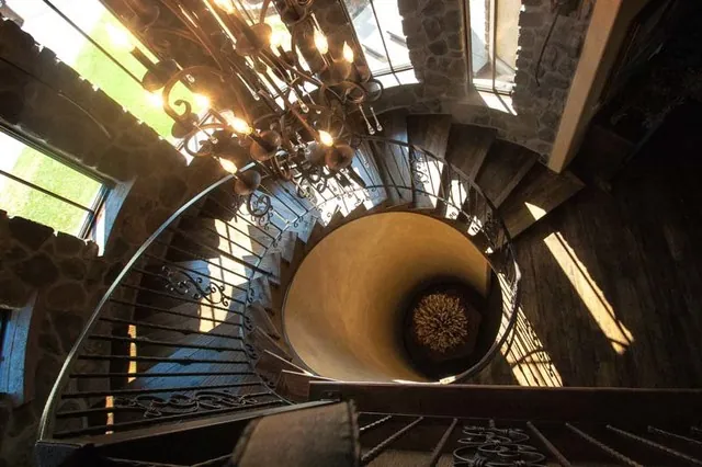 Tuscan Villa custom home — Staircase Mid Landing Custom Woodwork